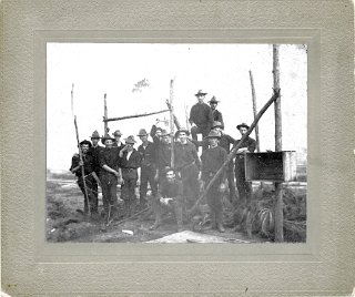 Members of Company H, 1st. Wisconsin,  Spanish-American War, at Camp Cuba Libra, Jacksonville, Florida, circa 1898.  Tearing down the camp. Men pictured are: Henry Klassy, Will Schutsy (Schuetze), Fred Phillips, Louis Dodge, Fred Odell, Stanley Dritz (Dietz), Louis Dunaway, Art Musselman, Pete Woodle, Clyde Noble, Jimmy Hodges, Sam Hoesley (Hosely), Herman Somerfeldt, Archie Fessenden, William Rolley (Rolly).